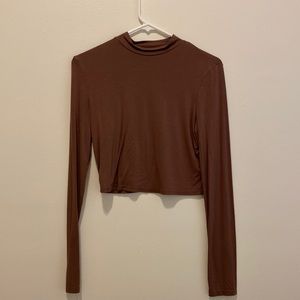 Three cropped, turtle neck shirts